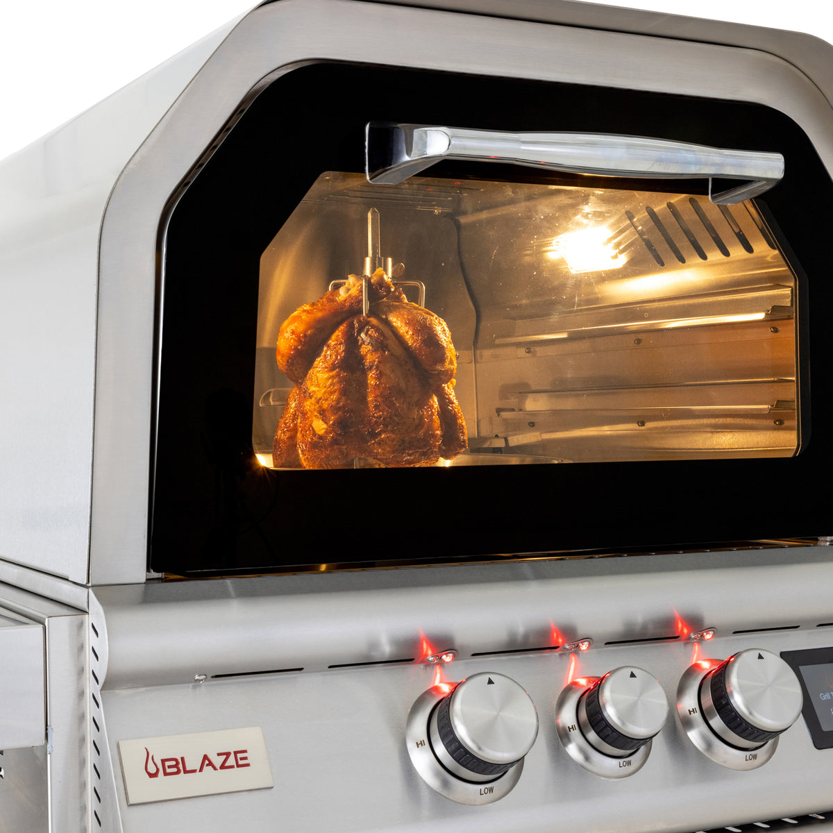 Vertical rotisserie chicken cooking in the Blaze 26" outdoor oven