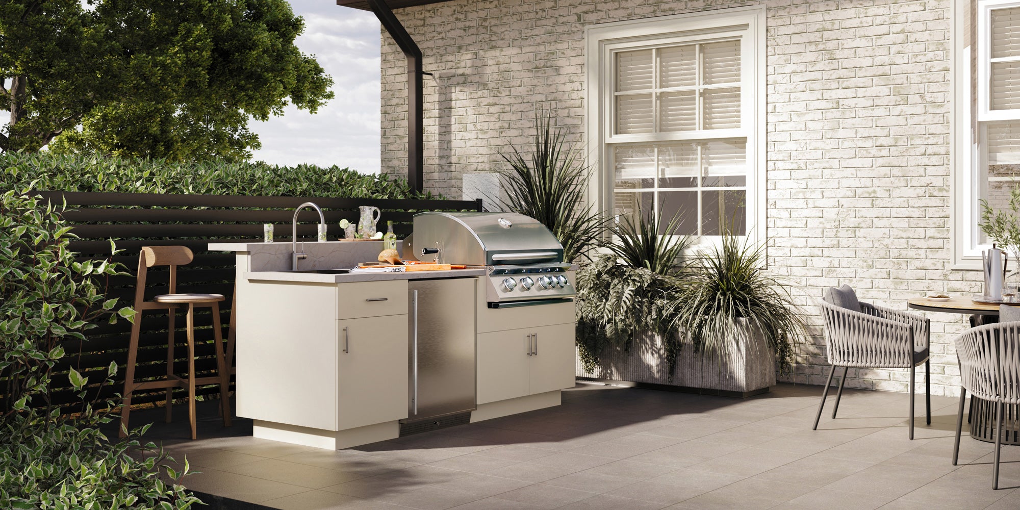 Custom outdoor kitchen with built-in gas grill, side burners, and prep area