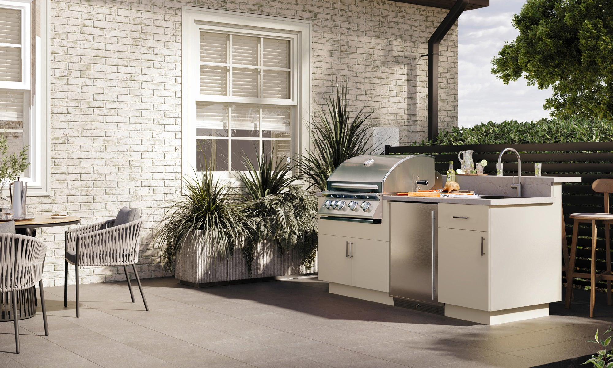 Premium outdoor kitchen with built-in gas grill, charcoal smoker, pizza oven, side burners, and storage drawers.